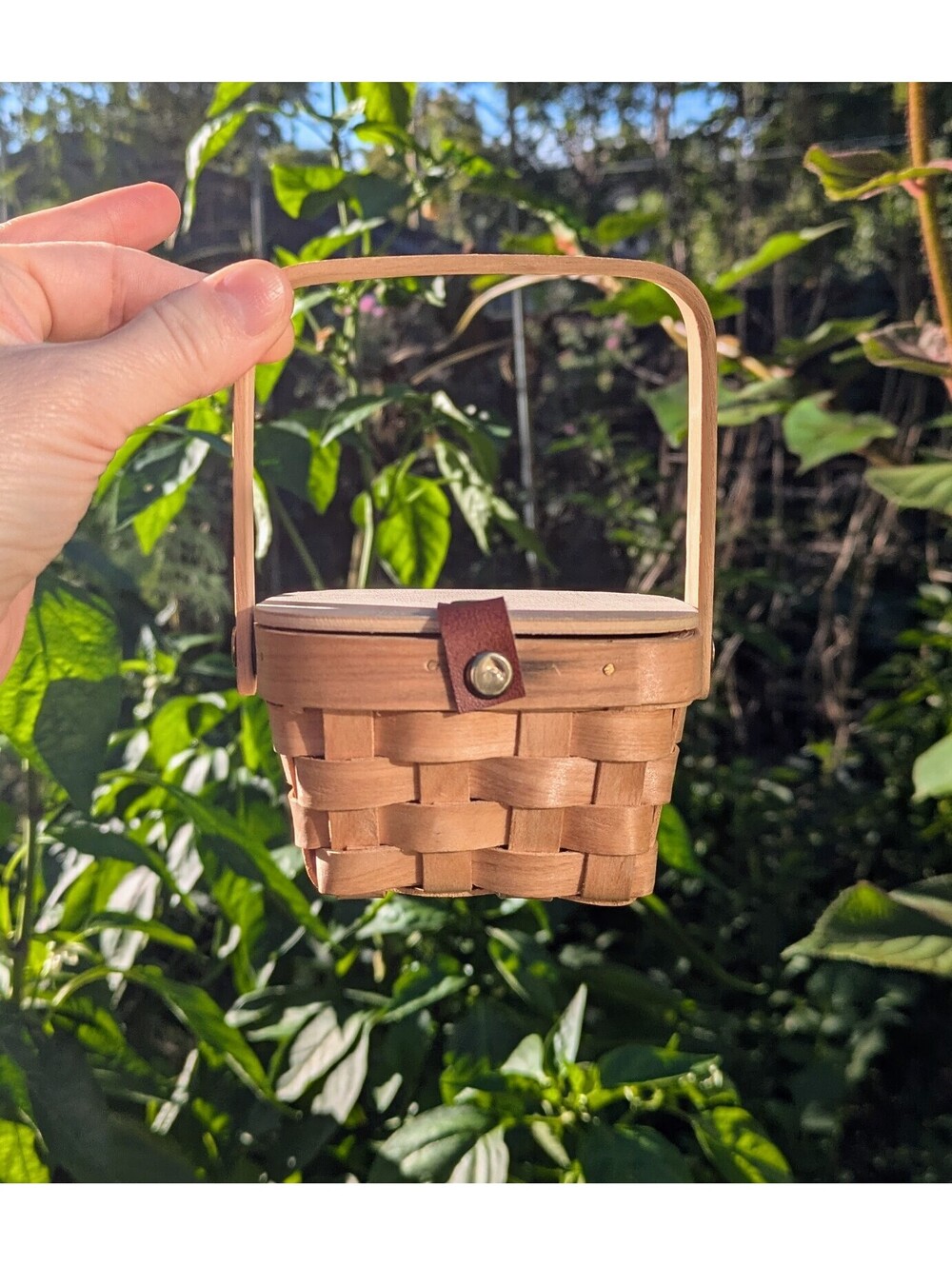Tiny picnic basket filled with trinkets, vintage jewelry, old key, etc.